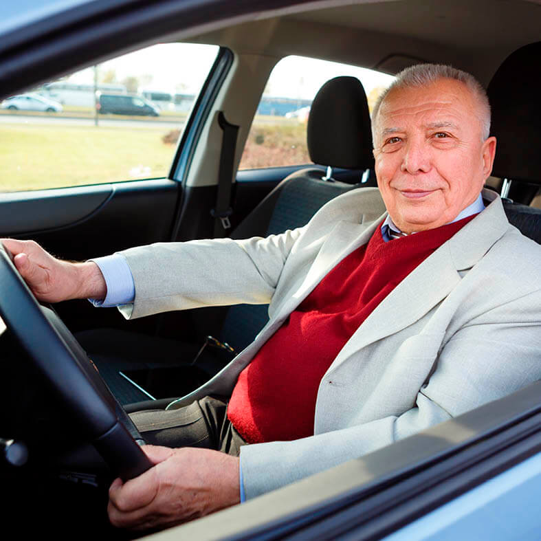 Rentner sitzt im Auto | Sicherheit im Straßenverkehr ist insbesondere für Senioren wichtig